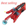 A red superhero launcher wrist toy set with suction cup darts and a black blaster, shown in a close-up view.