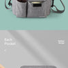 A gray front pocket for towels and wipes, featuring a small slot and a side strap.