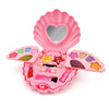 A pink makeup toy set in a shell-shaped case with various colored cosmetic items inside.