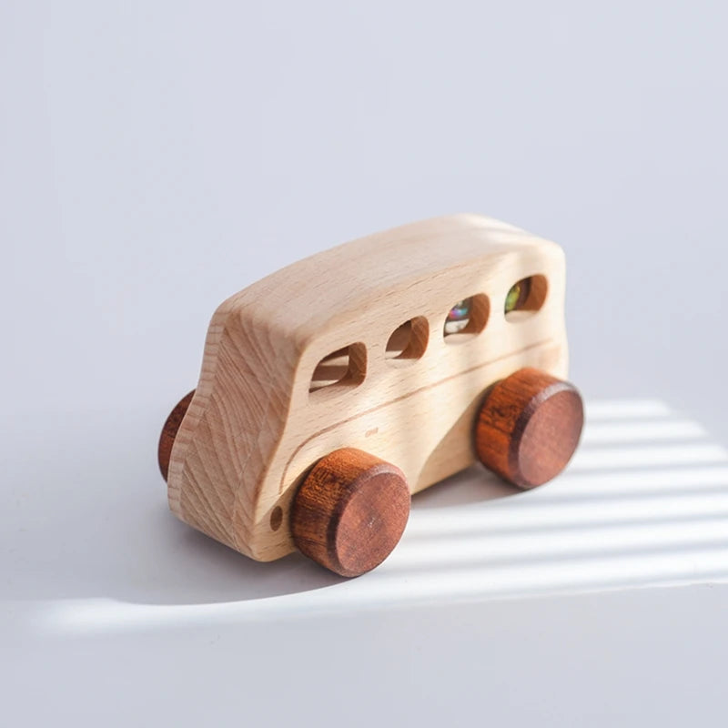 A wooden Montessori push cart toy shaped like a bus, featuring natural wood and small colored windows.