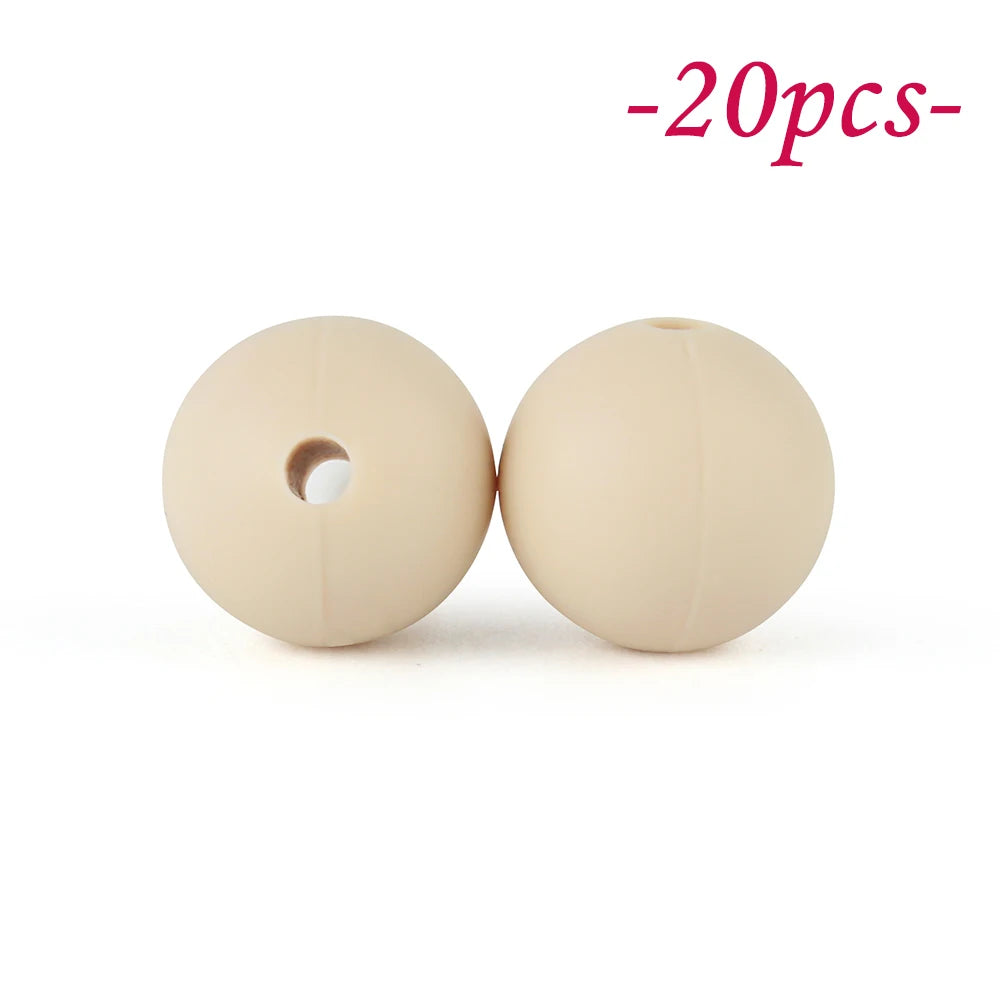 Two round, beige silicone beads are shown against a white background.