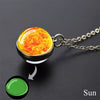 A pendant necklace featuring a glowing orange and yellow glow-in-the-dark substance resembling the sun.