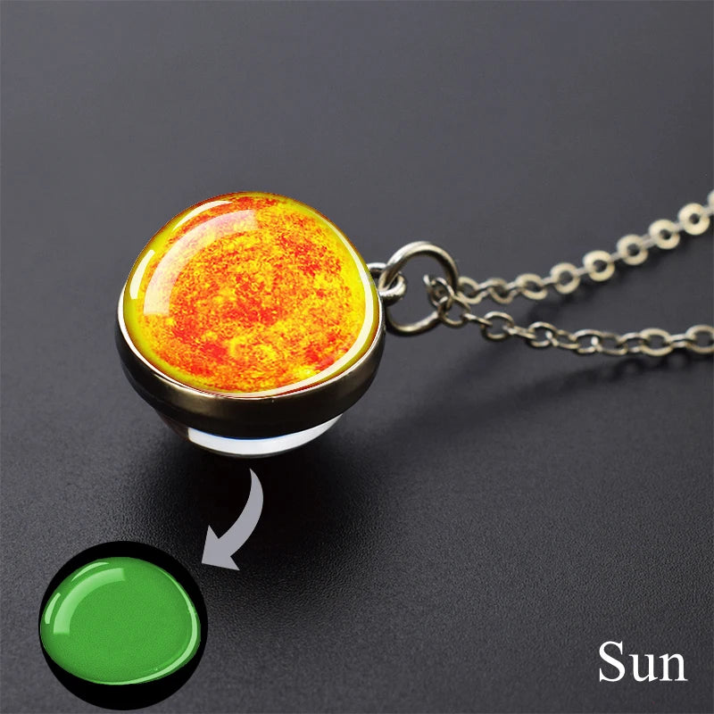A pendant necklace featuring a glowing orange and yellow glow-in-the-dark substance resembling the sun.