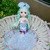 A mermaid doll with teal hair and a sparkly blue dress adorned with sequins and floral accents sits in a woven basket.