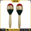 A pair of hand-painted wooden maracas with natural wood handles and red tops.