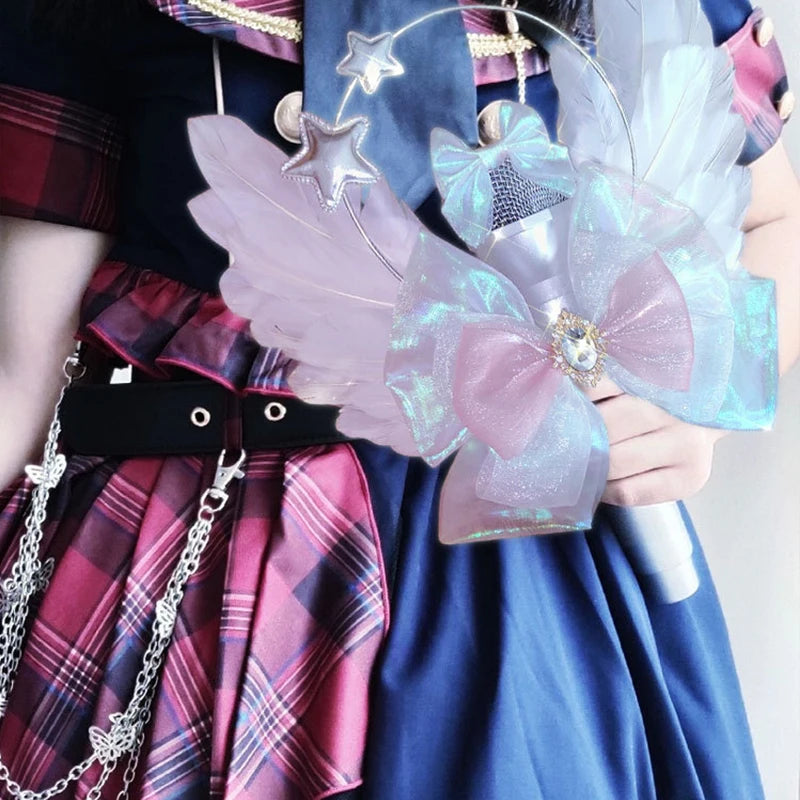 A person holds a realistic toy microphone prop featuring iridescent purple and blue wings and a bow.