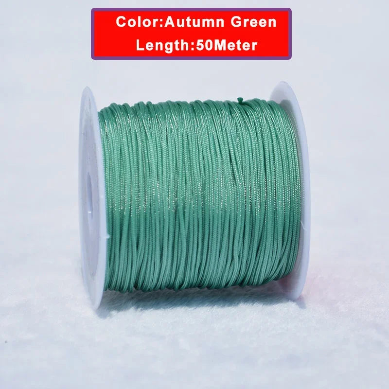 A spool of 50 meter long Autumn Green 0.8mm Nylon Knotting Cord for jewelry making.