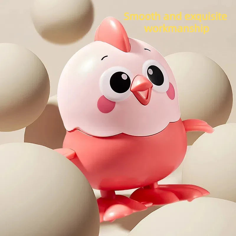 A smooth pink wind-up chick toy with large eyes and a pull chain, set against a light background.