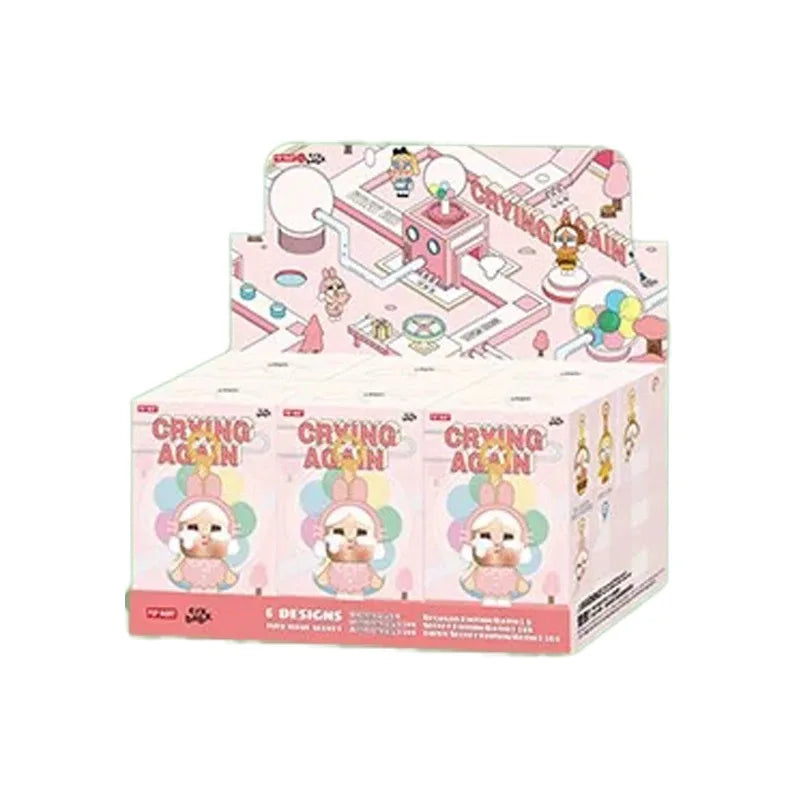 A box of Crybaby Vacation Mode On Vinyl Figure blind box featuring pink and white packaging.