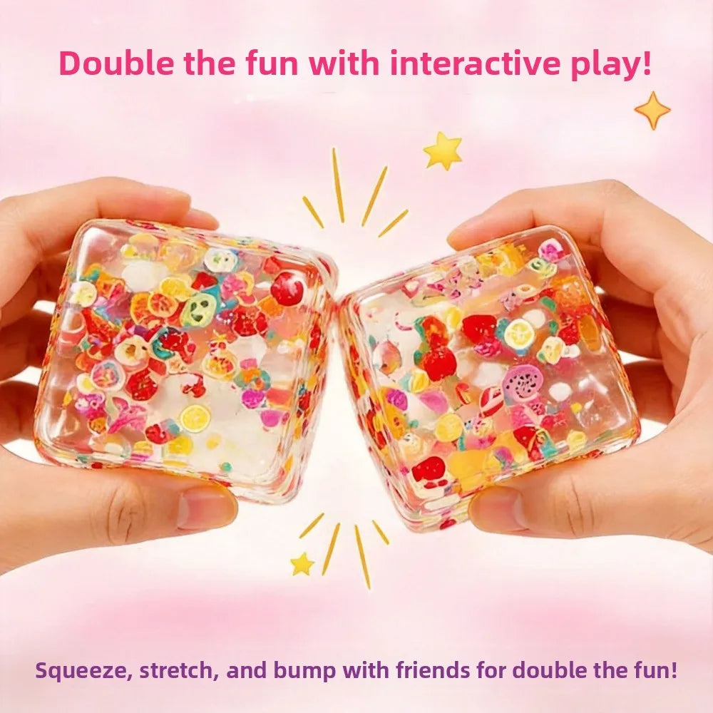 Hands hold two colorful fruit ice cube stress balls demonstrating squeezing and stretching for interactive play
