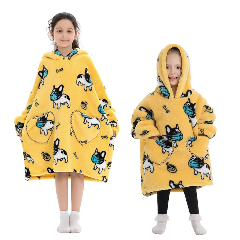 A young girl models a yellow cozy kids flannel hoodie sweater with a hood and animal print.
