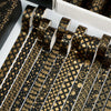 A set of 20 rolls of black and gold foil washi tape featuring intricate geometric and floral patterns.
