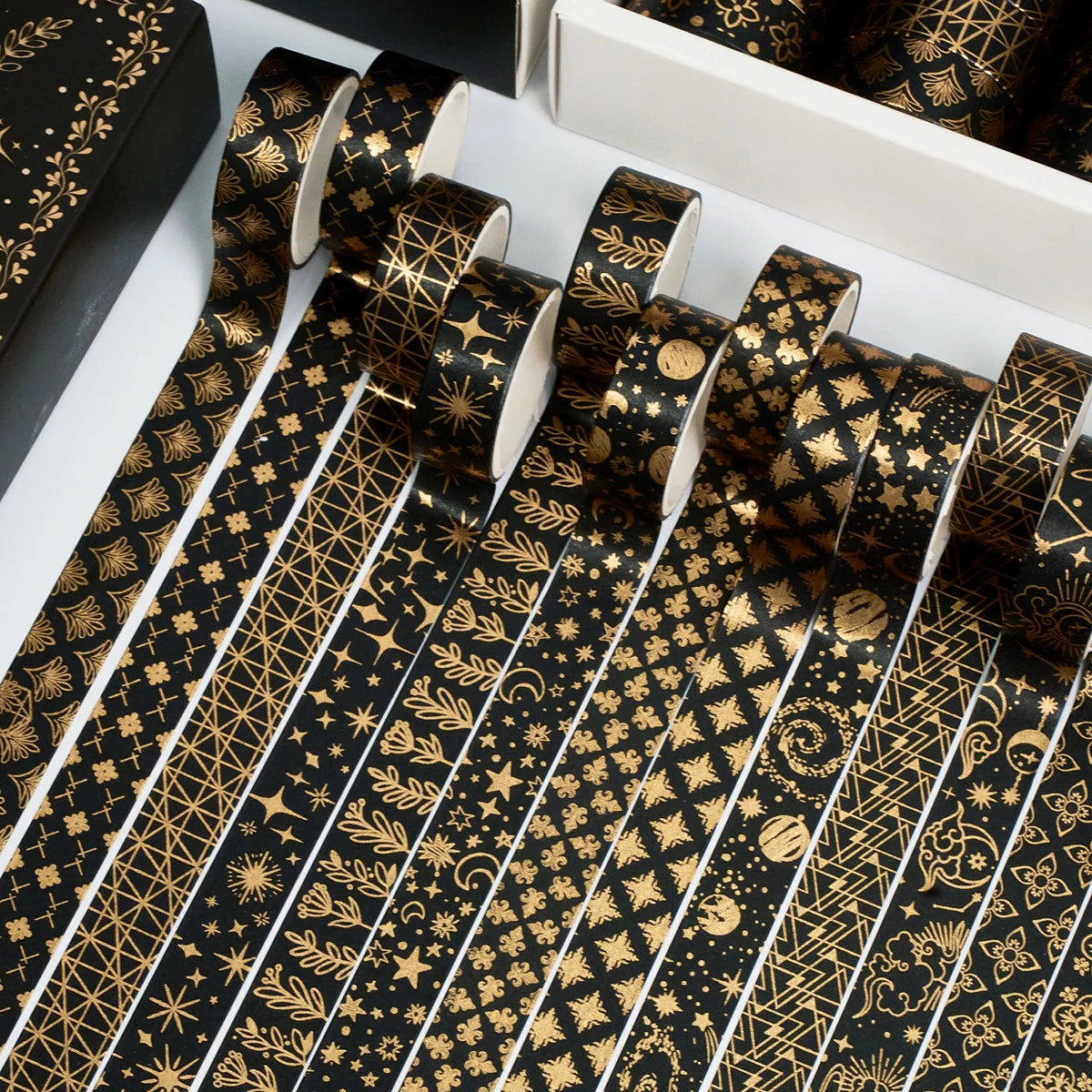 A set of 20 rolls of black and gold foil washi tape featuring intricate geometric and floral patterns.