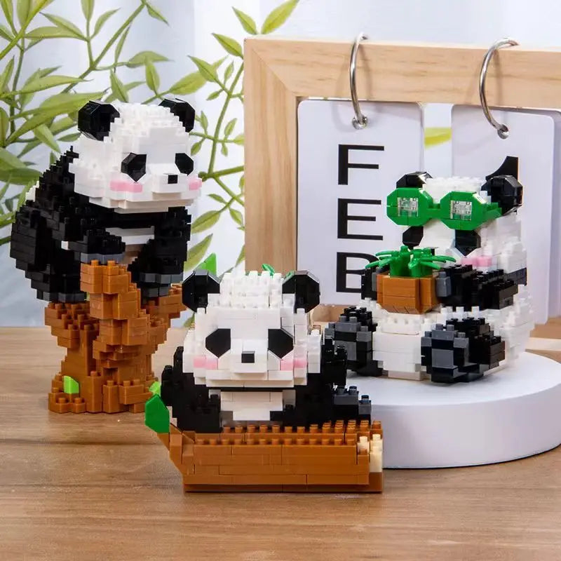 A set of mini panda building blocks featuring black and white panda figures displayed in a wooden frame.