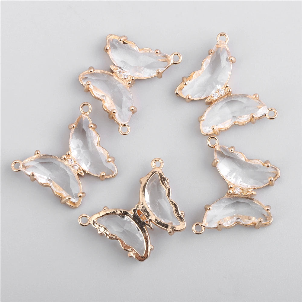 Gold-toned crystal butterfly charm beads arranged in a circular pattern for jewelry making