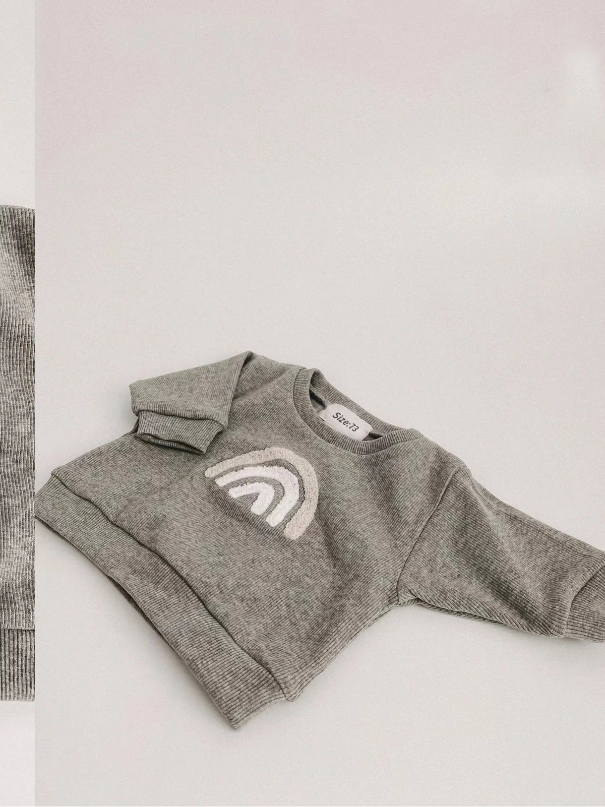 A gray knit long-sleeve top for a baby girl outfit set is displayed on a white background.