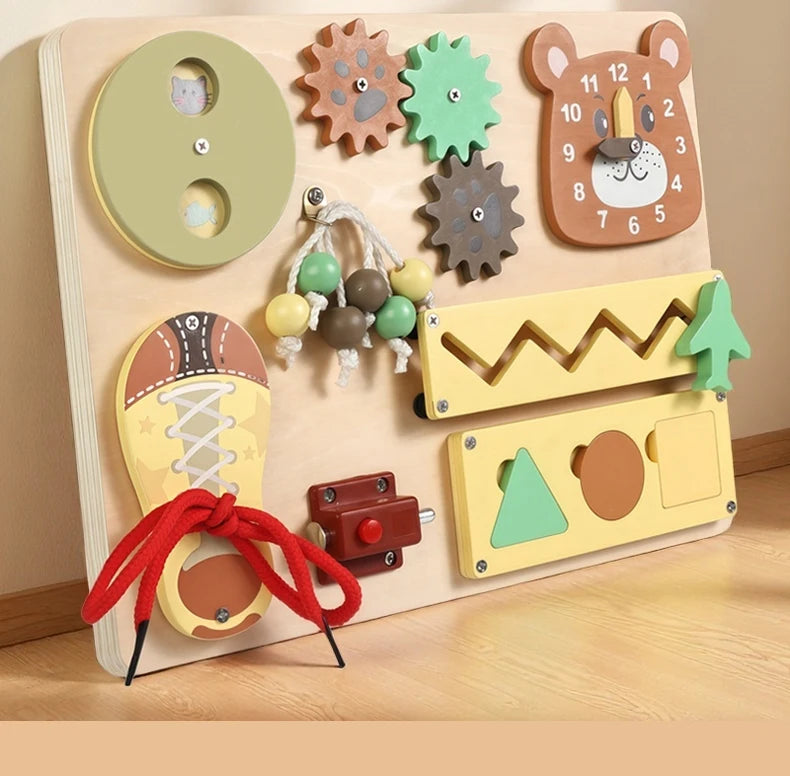 A wooden busy board for children featuring various musical and sensory activities like a bear clock, gears, and a shoe.