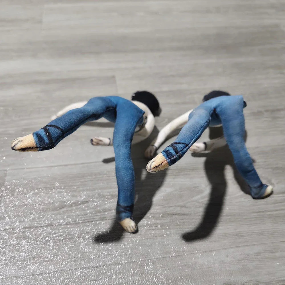 A plush doll resembling L Lawliet wearing blue pants and white hair is posed on a light wooden surface.