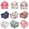 A collection of various fabric upholstered mini sofas and armchairs in floral, plaid, and solid colors for dollhouses
