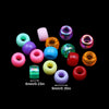 A collection of colorful pony beads in various shades including pink, purple, green, and orange, displayed against a black ba