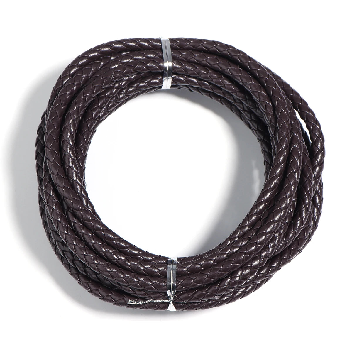 A round braided leather cord in dark brown is shown coiled for jewelry making and DIY crafts.
