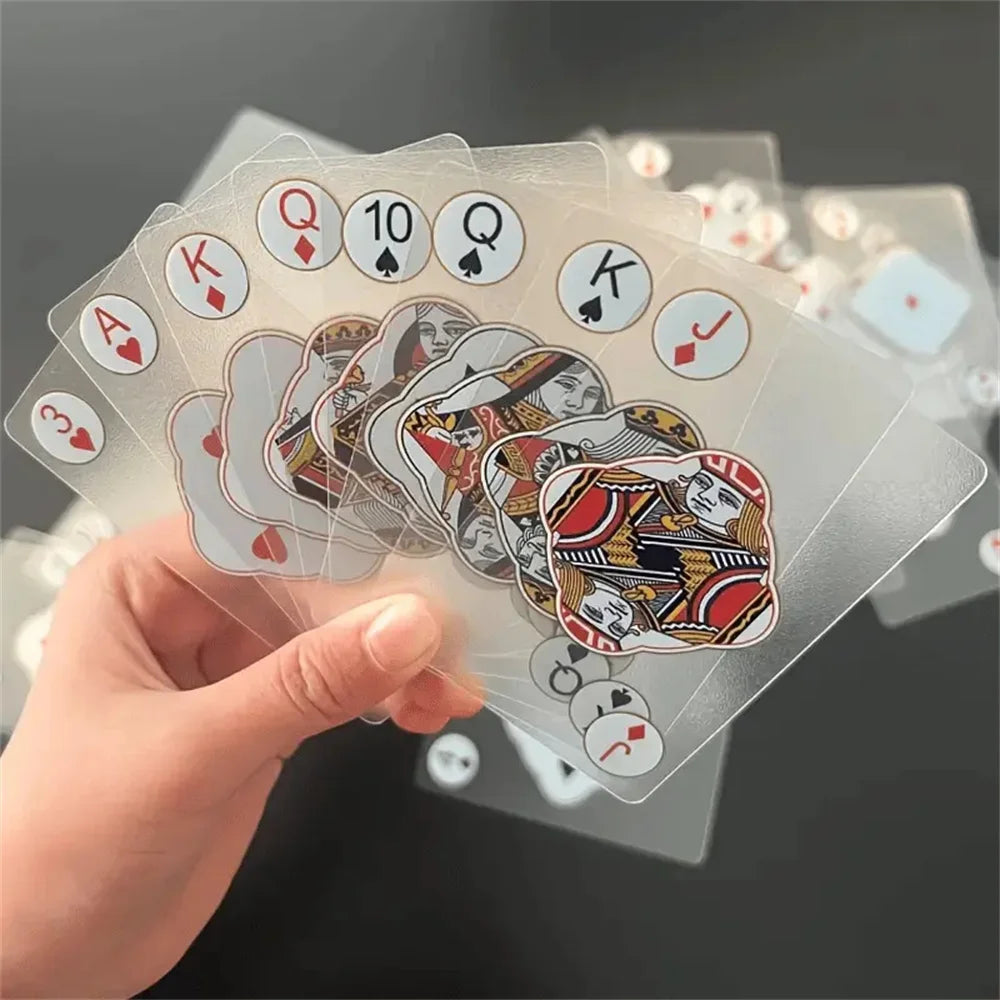 A hand holds a stack of waterproof transparent playing cards featuring Ace, King, Queen, and Ten cards.