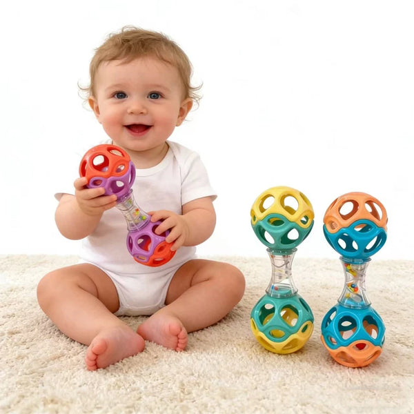 A baby is holding a colorful rubber teething and grasping rattle toy.