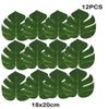 Twelve artificial tropical palm leaves measuring 18 by 20 cm for party decor
