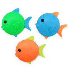 A set of three colorful plastic fish toys in green, blue, and orange.