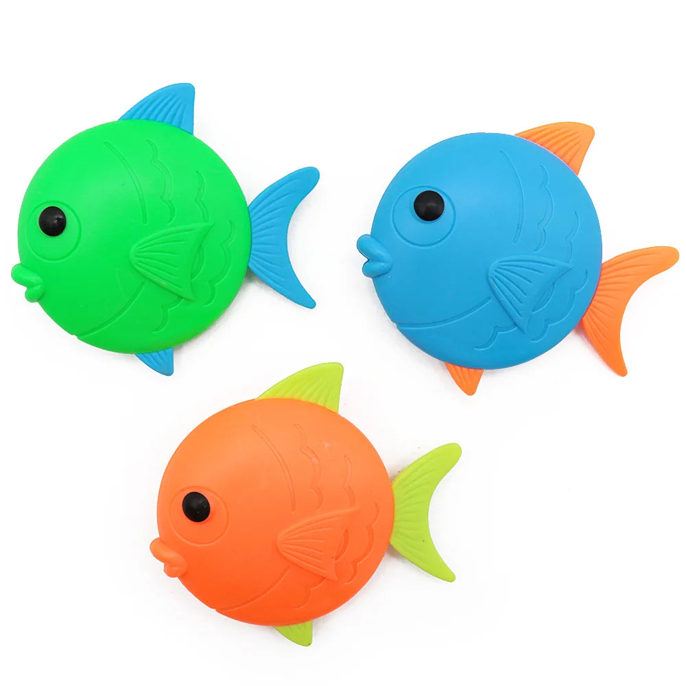 A set of three colorful plastic fish toys in green, blue, and orange.