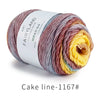 Spool of Fairyland long distance cake ball yarn showing a gradient blend of multicolored fibers.