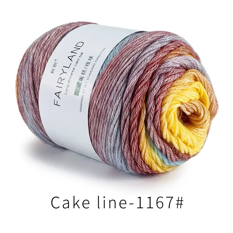 Spool of Fairyland long distance cake ball yarn showing a gradient blend of multicolored fibers.