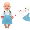A baby doll wearing a blue outfit set with a white accessory and a white ring.