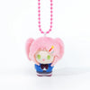 Pink-haired chibi plush charm with a pink beaded necklace and blue outfit