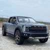 A gray 1:20 scale Ford Raptor F150 diecast model truck with lights and sound effects parked on a concrete surface.