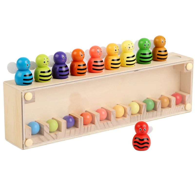 A wooden color matching toy featuring ten small, brightly colored, egg-shaped figures arranged in a row.