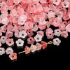 A pile of pink and red gradient acrylic bellflower beads for jewelry making