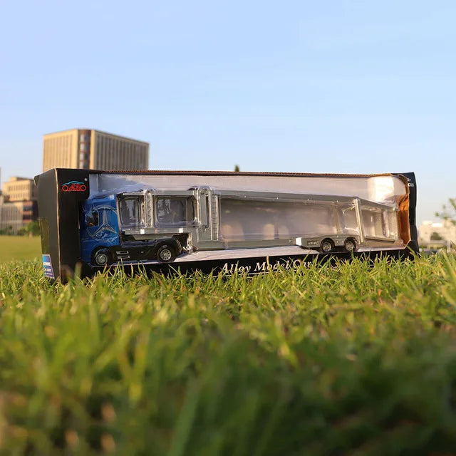 A 1:50 scale diecast alloy container truck with lights and sounds displayed on grass.