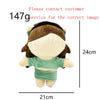 A plush doll resembling Eminem, XXXTentacion, and Frank Ocean with brown hair and a green top.