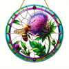 A round acrylic window hanging featuring a bee and a purple thistle flower design.