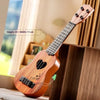 A wooden toy guitar with a heart design is shown next to a window.