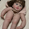 A lifelike reborn baby doll kit with painted vinyl parts, featuring brown hair and blue eyes.