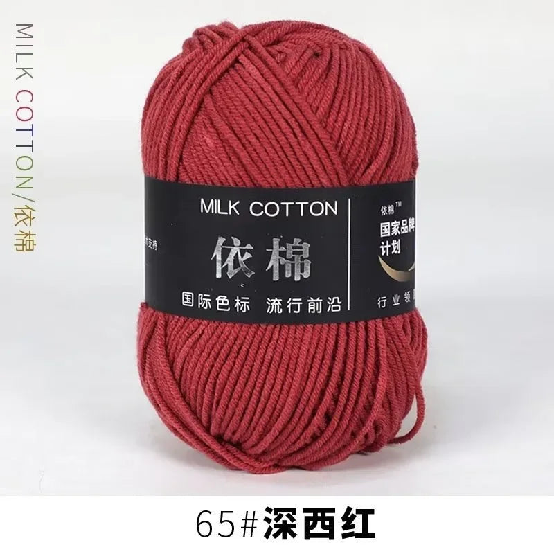 A skein of deep crimson milk cotton yarn labeled with Chinese characters and the designation 65# Deep Burgundy.