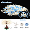 A collection of white and blue building blocks, including a tree structure and various components for construction.