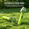 A lime green insect observation magnifier is lying on green grass, demonstrating its durable and child-safe features.
