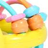 A close-up of a colorful sensory catch ball rattle toy with various colored plastic rings and a yellow base.