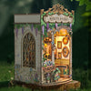 A miniature wooden book nook kit depicting Monet's studio with arched windows and floral details.