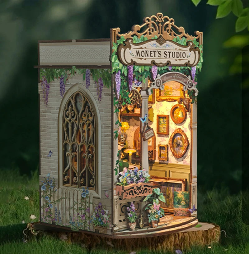 A miniature wooden book nook kit depicting Monet's studio with arched windows and floral details.