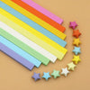 A collection of 27 colorful, rectangular paper strips in various shades are arranged diagonally and some are shaped into star