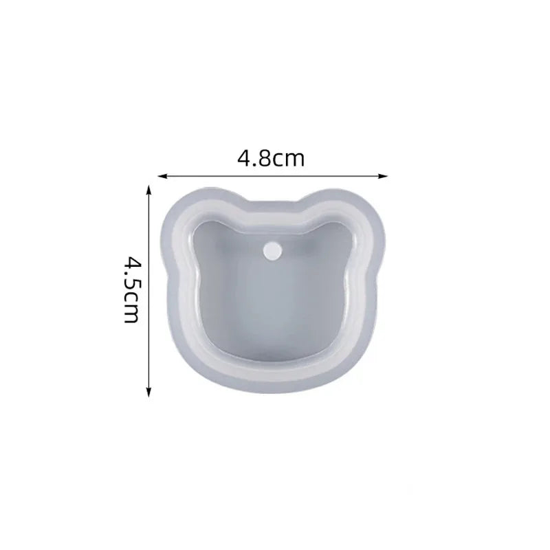A light gray heart-shaped silicone mold for resin jewelry making, shown from above.